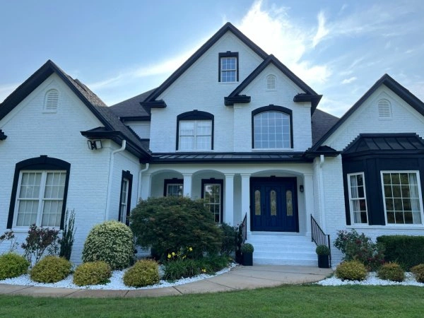 White two story house with dark trim painted by Color World Painting in Concord NC