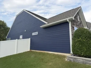 Exterior painting of a home by Color World Painting in Denver featuring dark navy blue horizontal siding