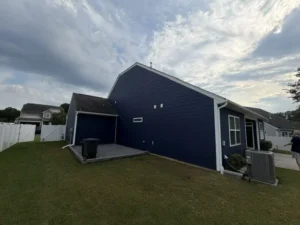Exterior painting with dark navy blue siding by Color World Painting in Denver enhancing the single-story home with crisp white trim